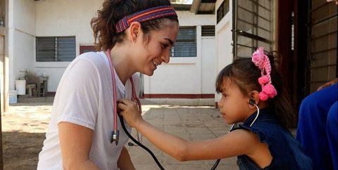 Connell School student tends to a child in Nicaragua